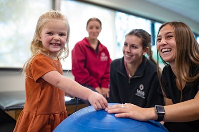 OT Students with young girl