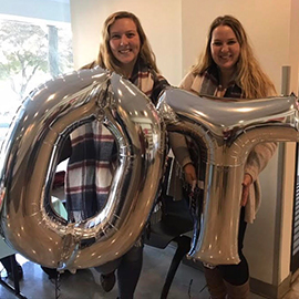 Students holding "OT" balloons