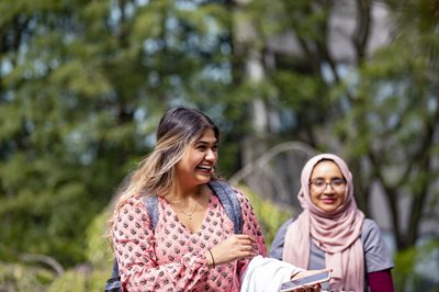 Two students outside smiling