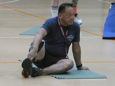 Adaptive athlete on yoga rug