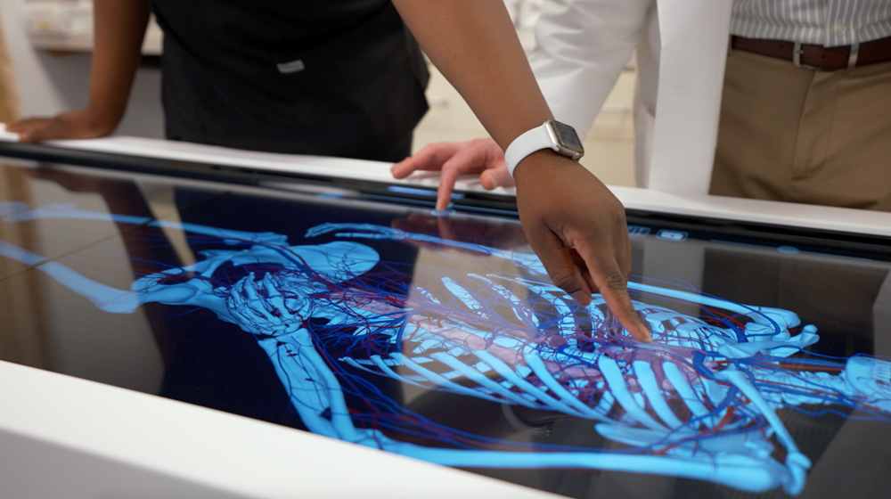 Photo of student and professor using the University's PA Simulation Lab table