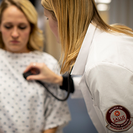 Physician Assistant student with a patient