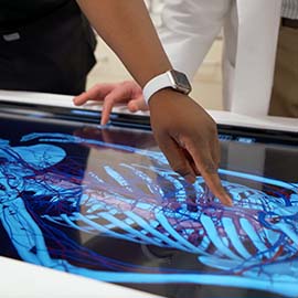 Photo of student and professor using the University's PA Simulation Lab table