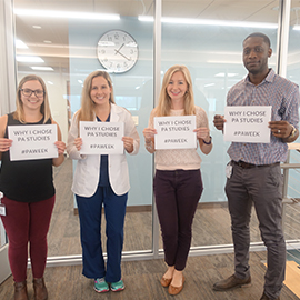 students holding signs for PA week