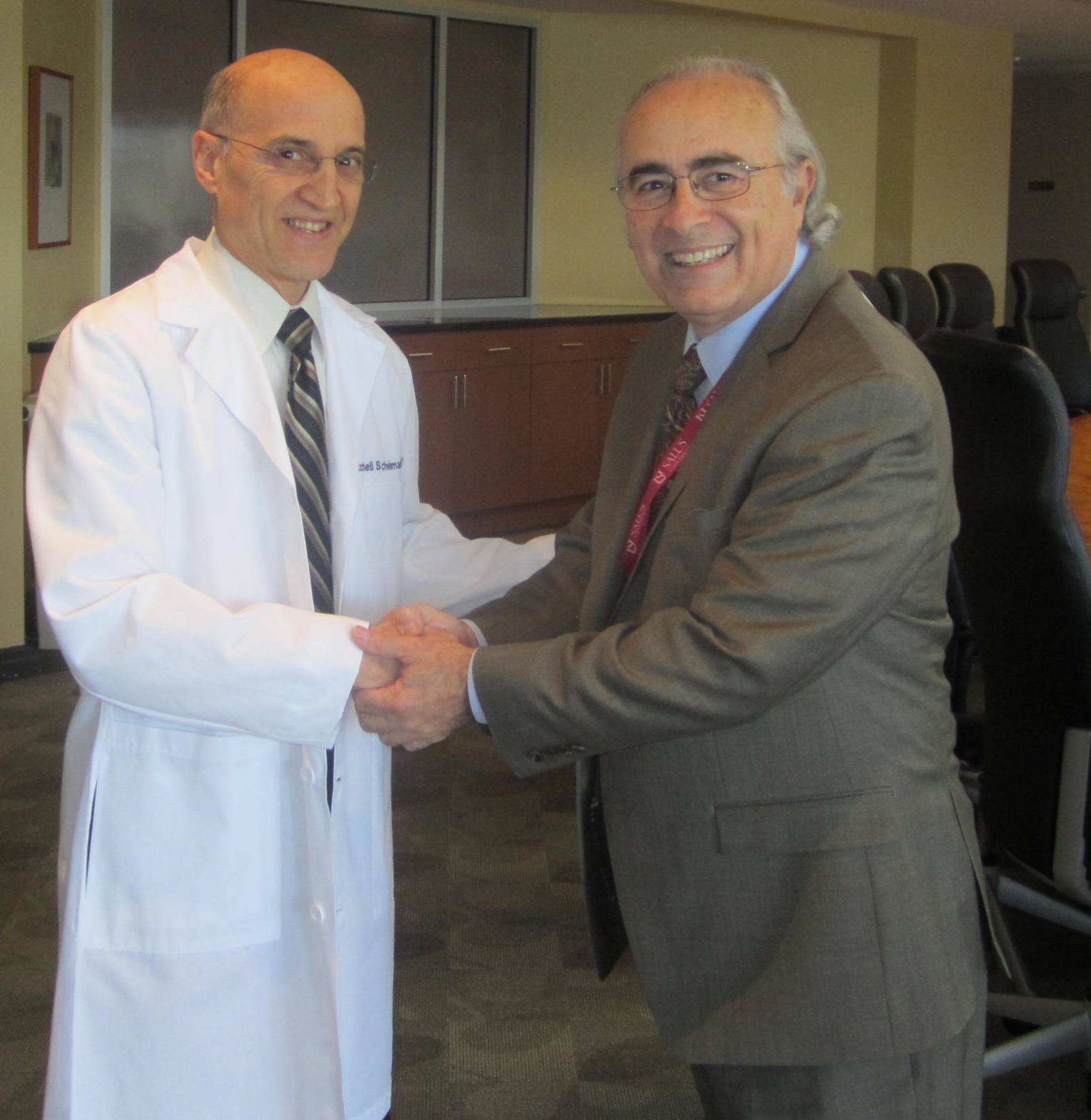 Dr. Scheiman shaking hands with Dr. DiStefano