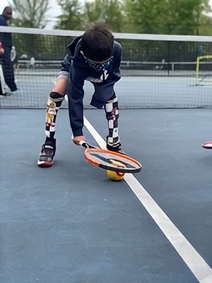 boy playing tennis