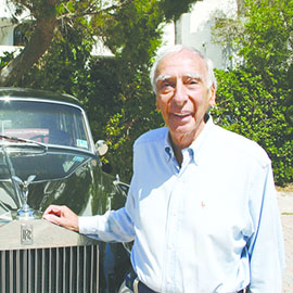 Dr. Robert J. Morrison standing in front of a car