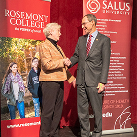 Michael Mittelman shaking hands with Rosemont president