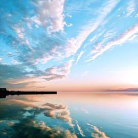 Photo of blue sky over blue water