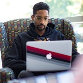 Student in the lounge with laptop