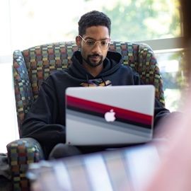 Student in the lounge with laptop