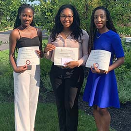 SEP students Dominica Dzakah, Charlene Caldwell and Ijeoma Onyejiukwa outside at closing ceremony.