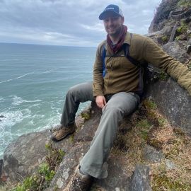 Slayton Hargraves sitting on the side of a mountain