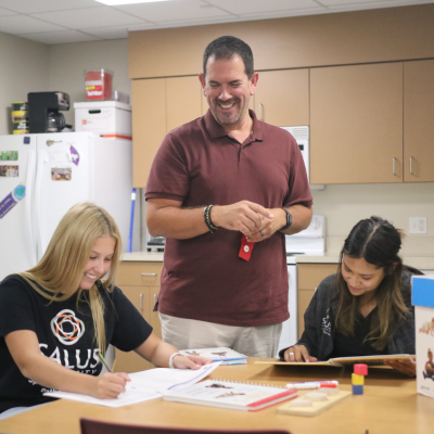 Bob Serianni working with students in class