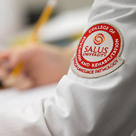 Salus SLP patch on a white coat