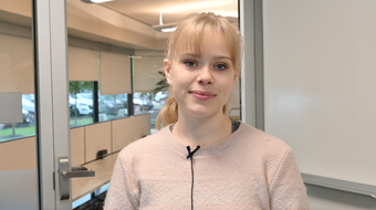 Student Sofiya Dorokhin shown in white sweater in Salus classroom.