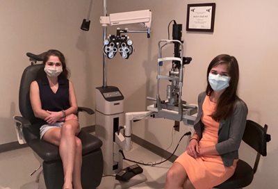 Dr. Susan (Barnes) Gresham with a patient in an exam room wearing masks