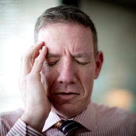 Man holding his head in pain