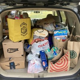 Boxes and bags of donations in car trunk 