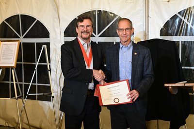 Victor Bray and Dr. Mittelman shaking hands