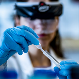 research student holding eyedropper