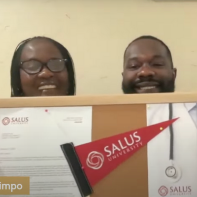 Simpio and mother holding Salus sign