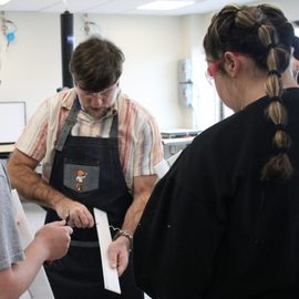 O&P faculty teaching students in the lab