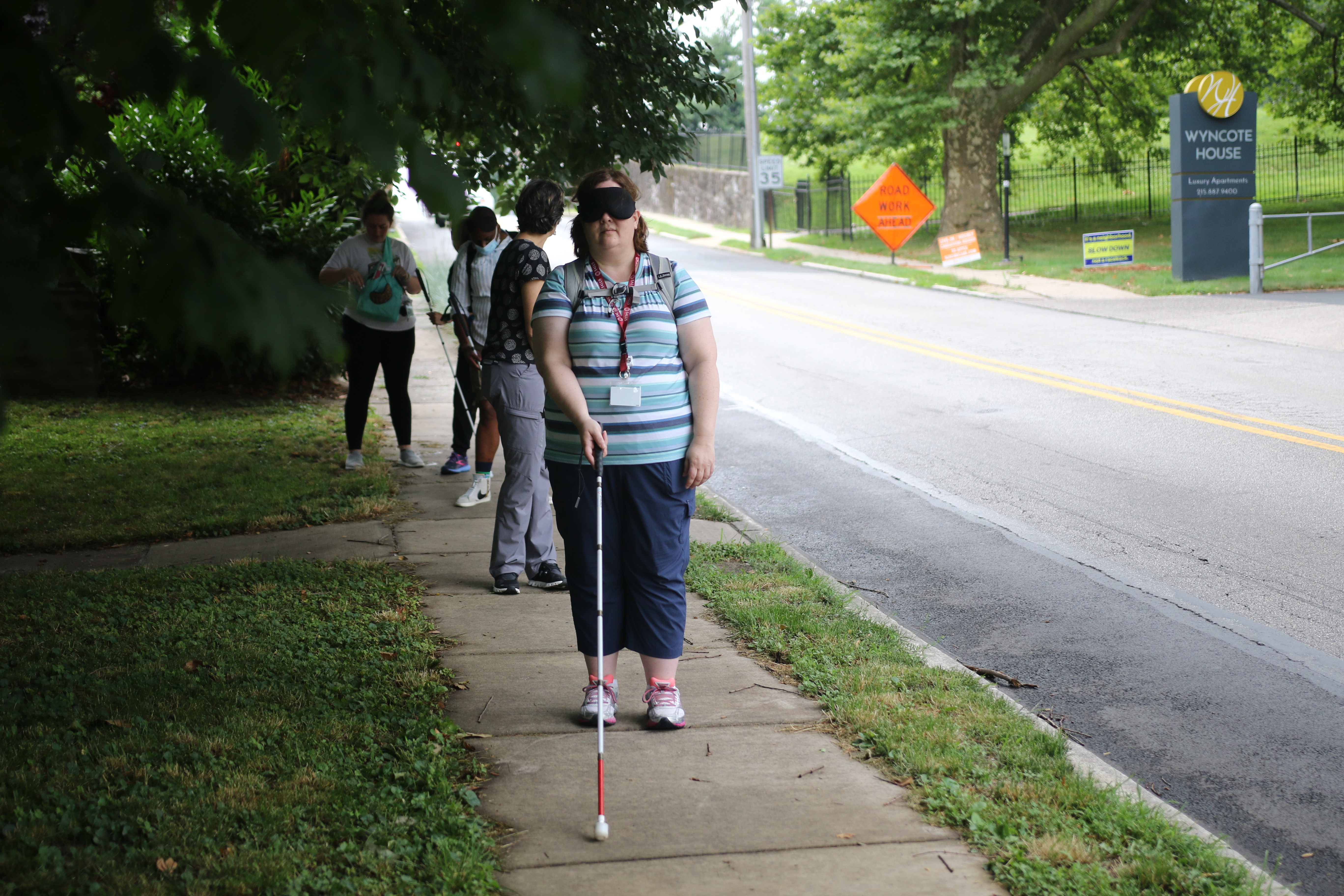 Student practicing with a white cane