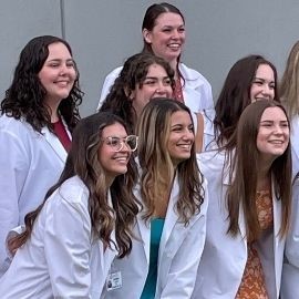 Students taking a photo at the white coat ceremony