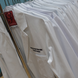 Long white coats on a rack