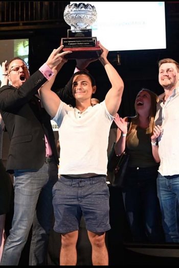 Photo of PCO/Salus student who won the student quiz bowl at Optometry's Meeting surrounded by a cheering crowd.