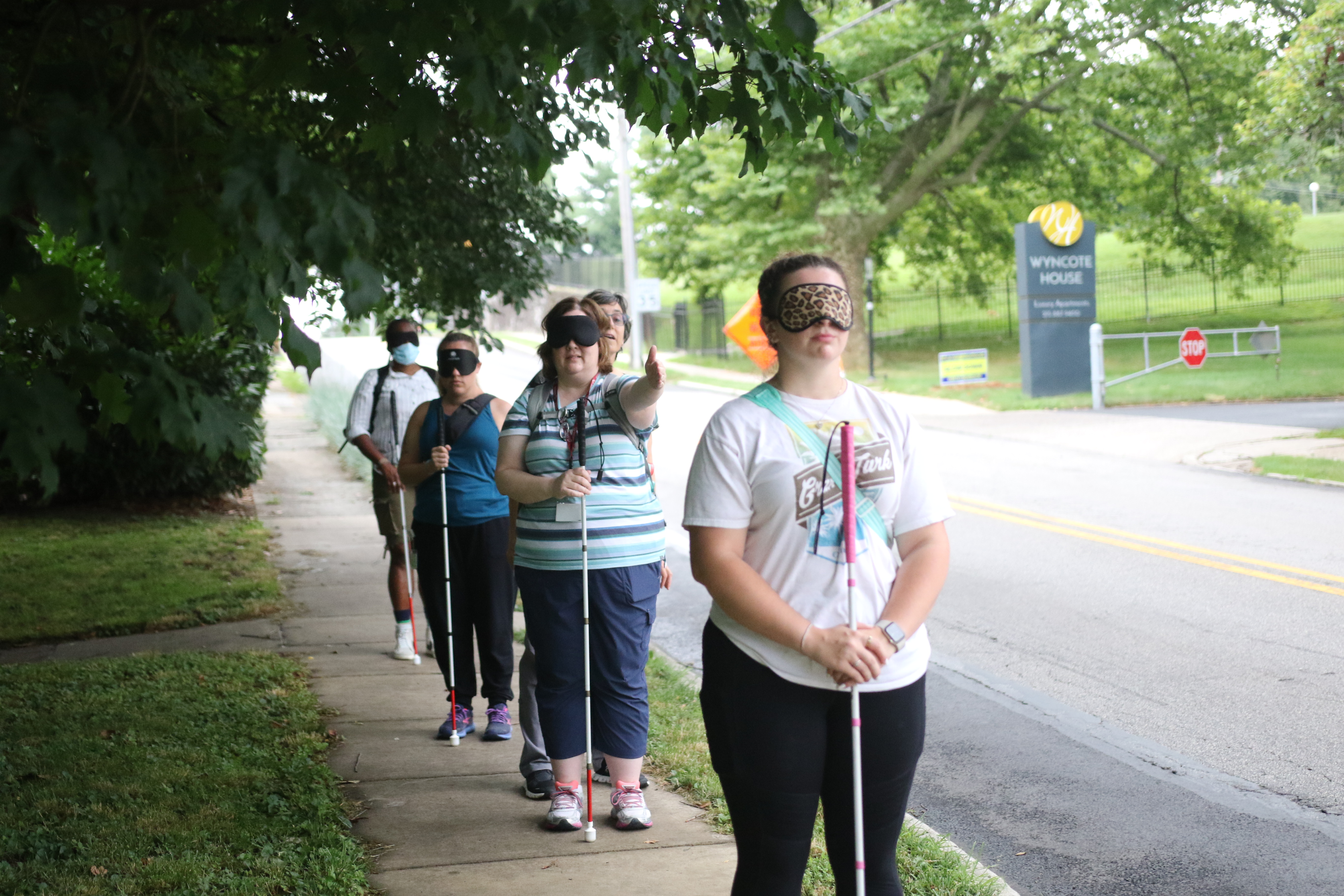 BLVS students with white canes practicing on the sidewalk