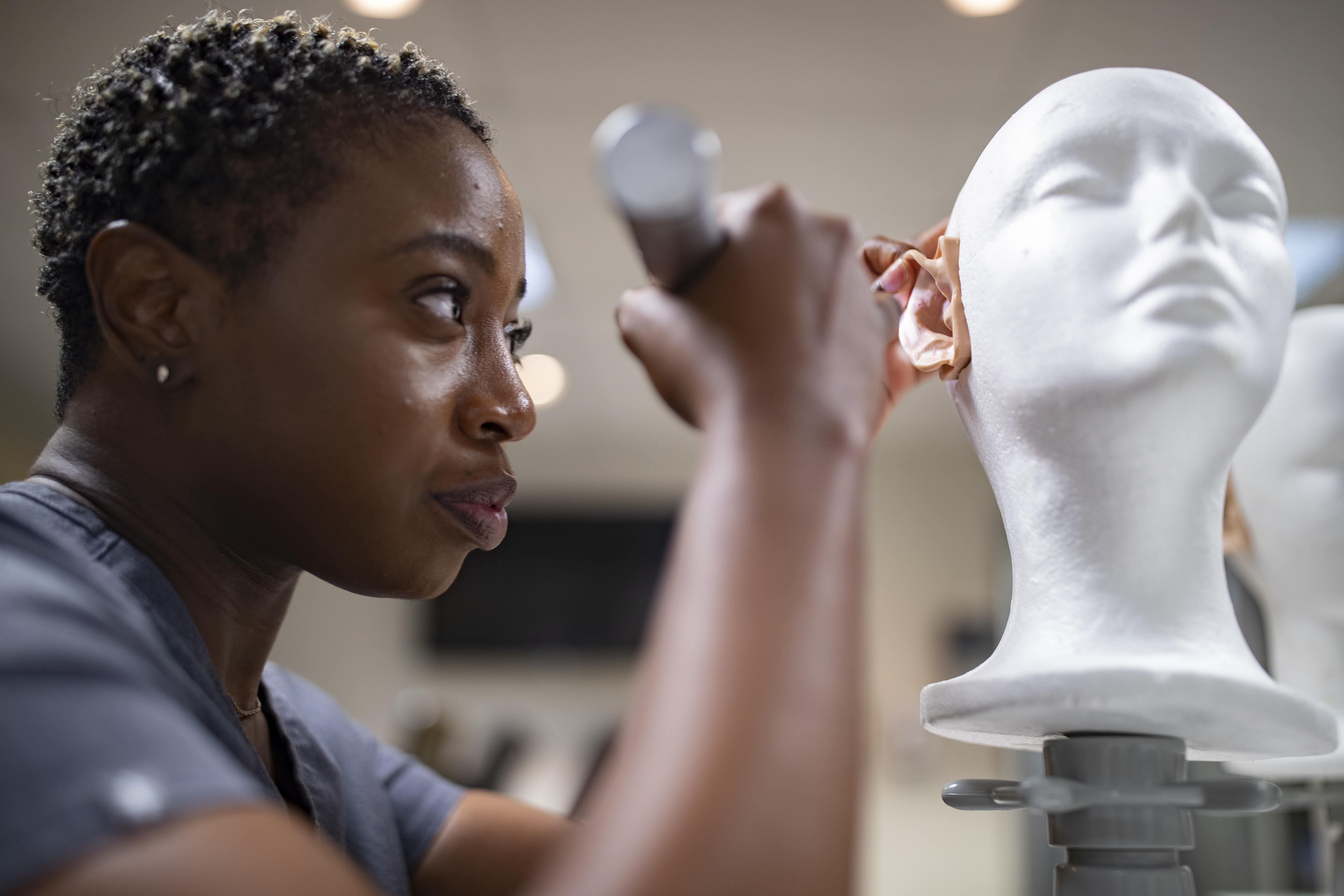 student examining an ear