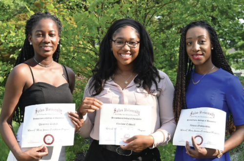 students holding certificates