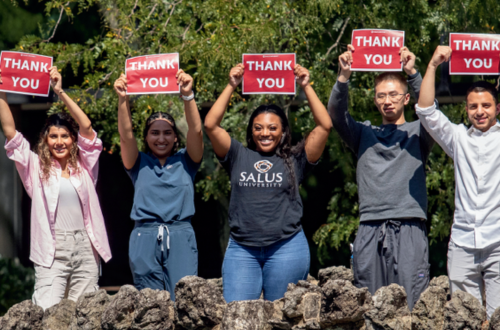 students holding thank you signs