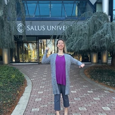 admissions counselor in front of Salus