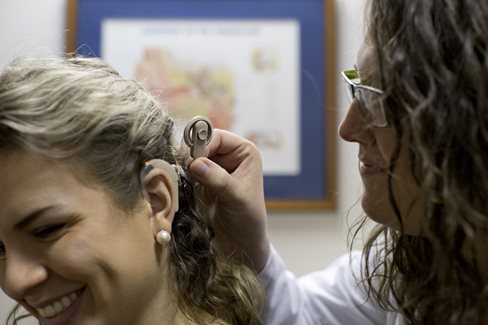 Dayle Paustian being fitted for a hearing aid