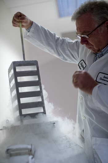 doctor lifting research materials out of container