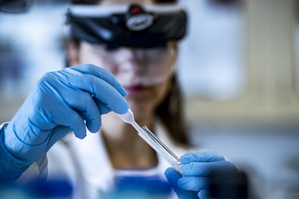 research student holding eyedropper