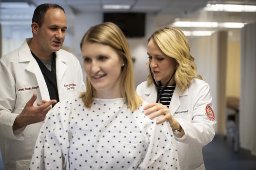 PA student and faculty working with a patient