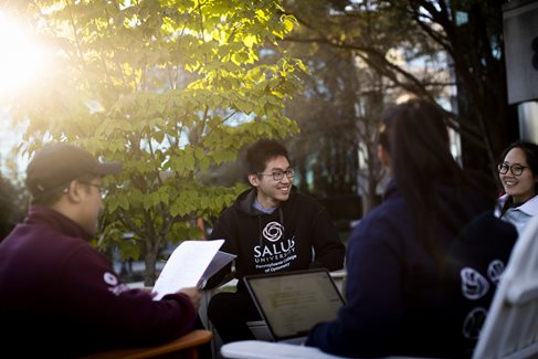 Students sitting outside on campus