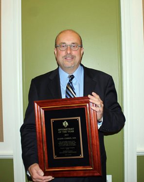 Alan Glenn holding POA award