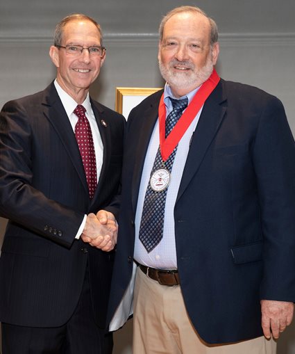 Dr. Brilliant and Dr. Mittelman shaking hands