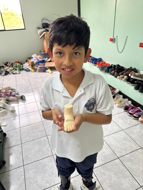 El Salvador kid holding foam foot