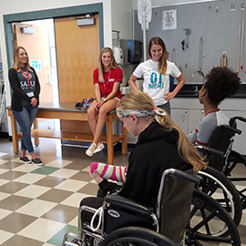 grad students speaking at middle school