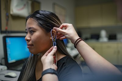 Picture of a woman being fitted for a hearing aid