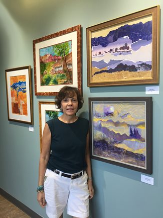 artist standing in front of artwork