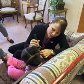 Dr. Lindsay Bondurant providing an ear exam