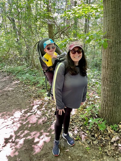 Caitlyn Foy hiking with baby on back