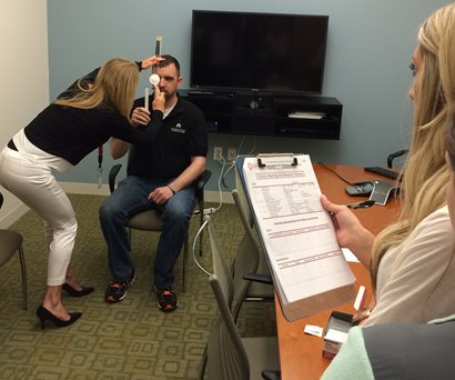 student conducting eye exam